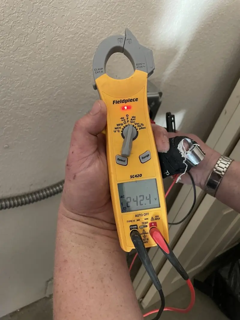 Voltage testing with clamp meter during Electrical Installation Services in Vidalia